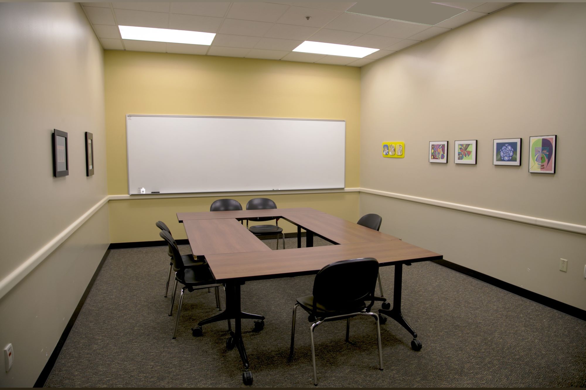 small conference room with desk and whiteboard