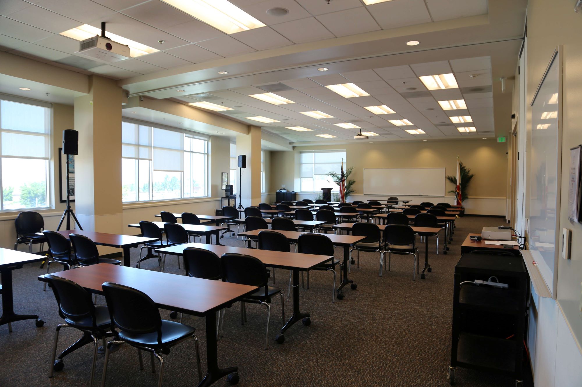 classrooms with many desks and a whiteboard