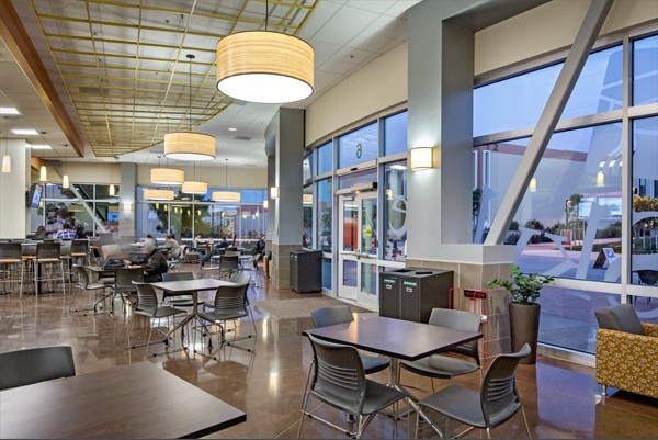 students study at tables throughout the spacious room