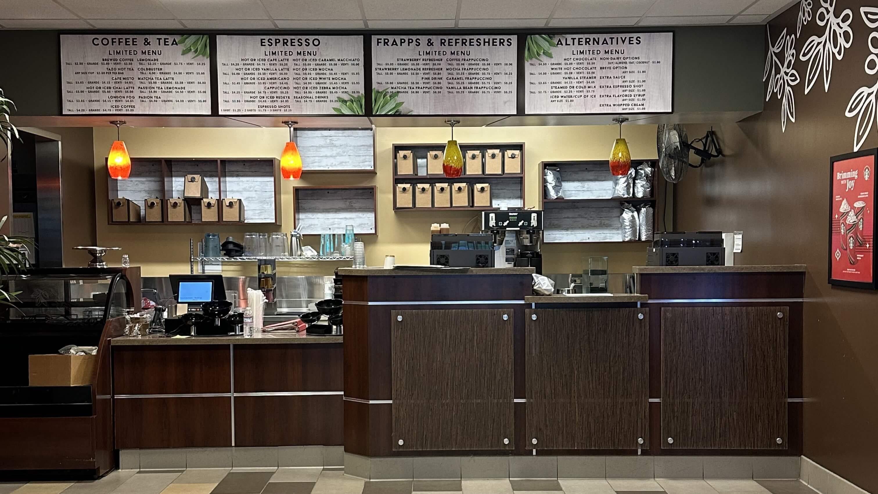 a view of the front dark-wood-paneled counter of the coffee shop