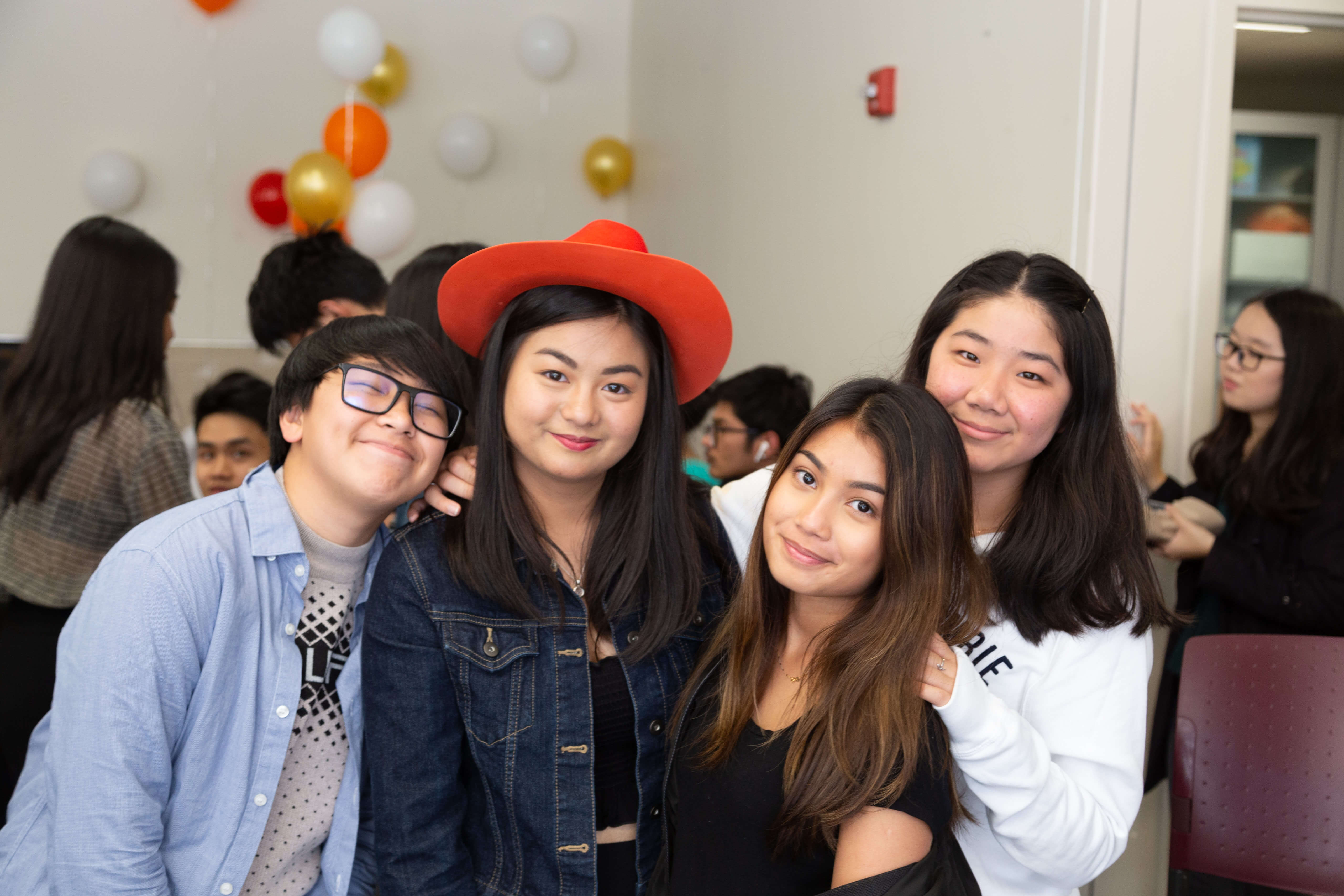 4 students at a party pose for a picture