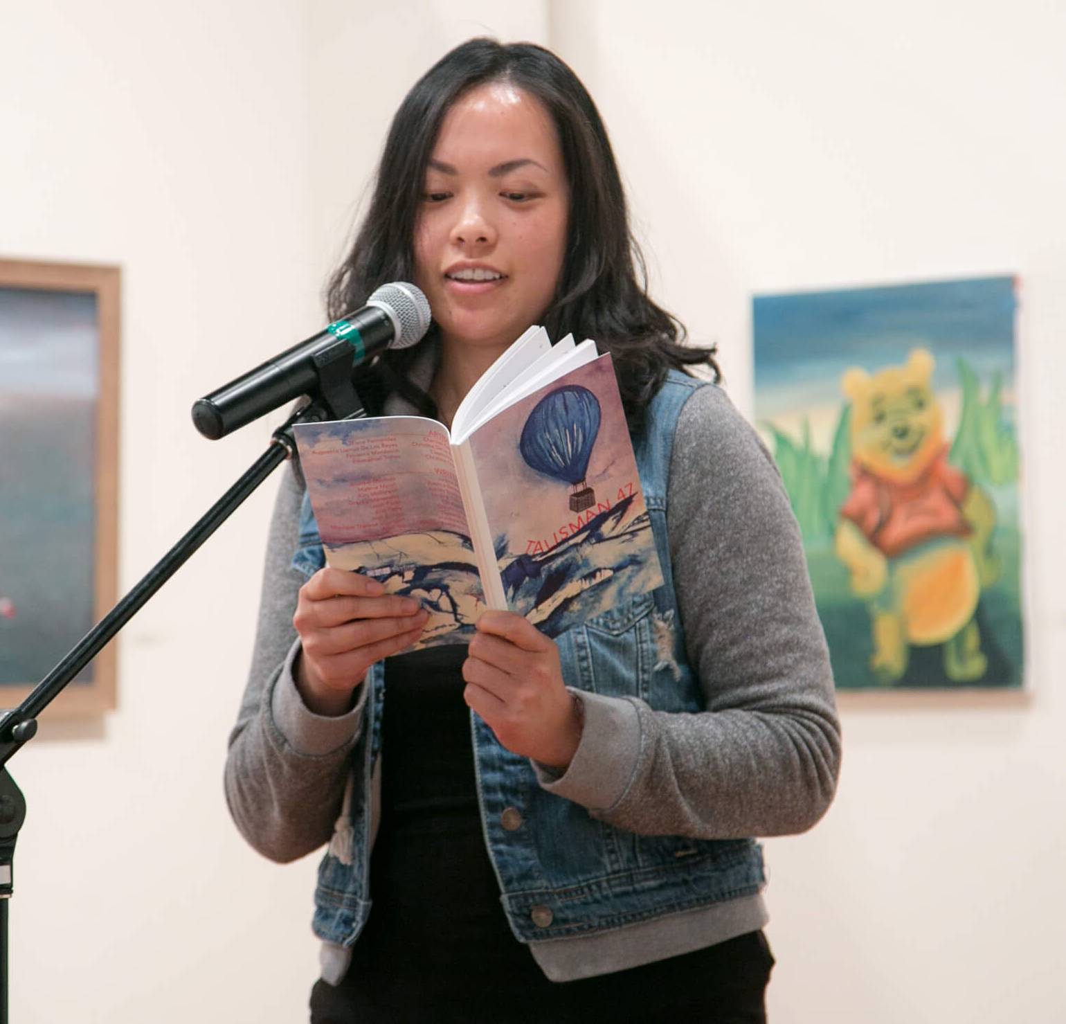 A student reading from a copy of Talisman