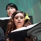 closeup on a singer in a choir performing with music