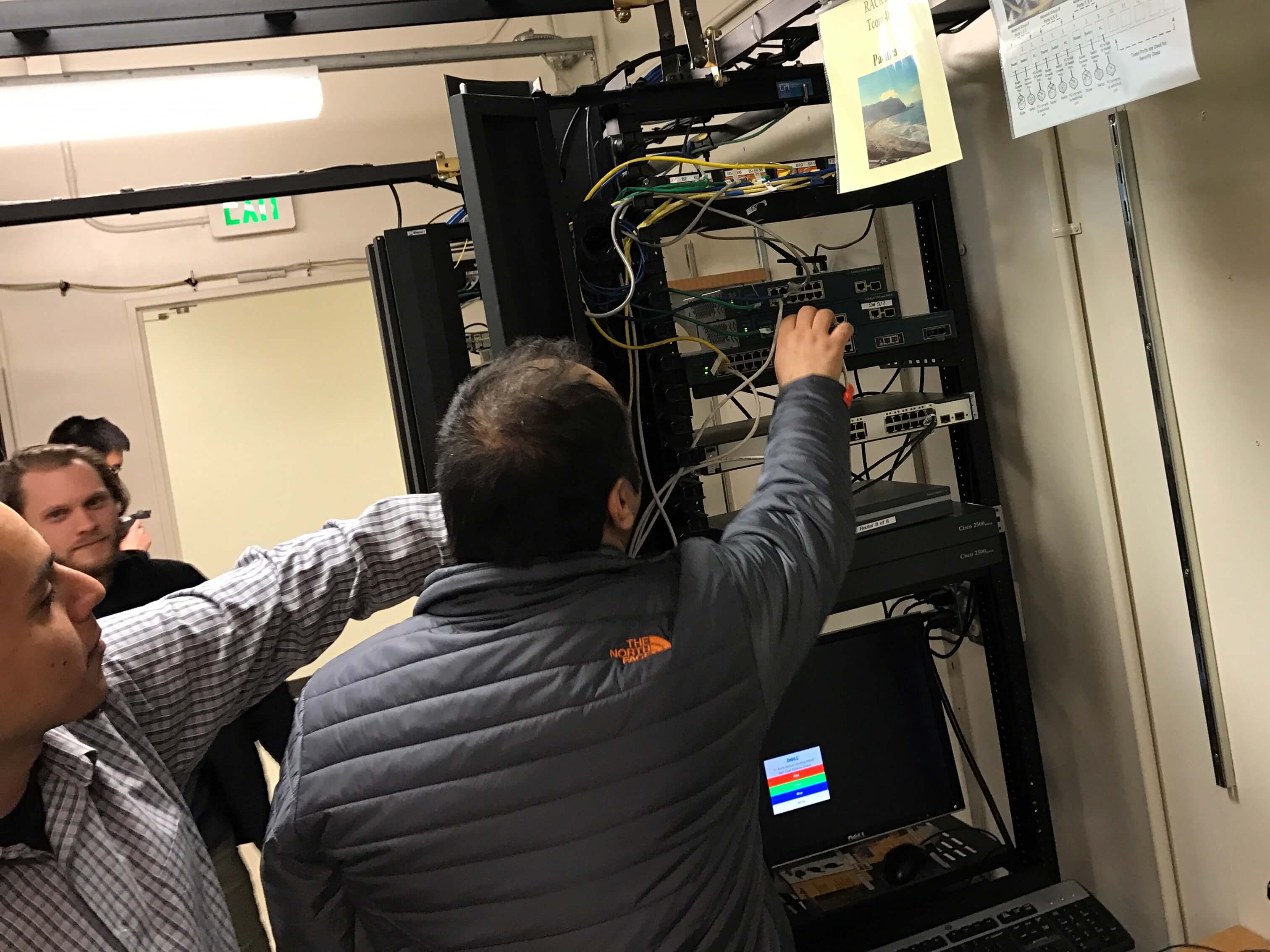 Student reaches to test out the equipment in the lab