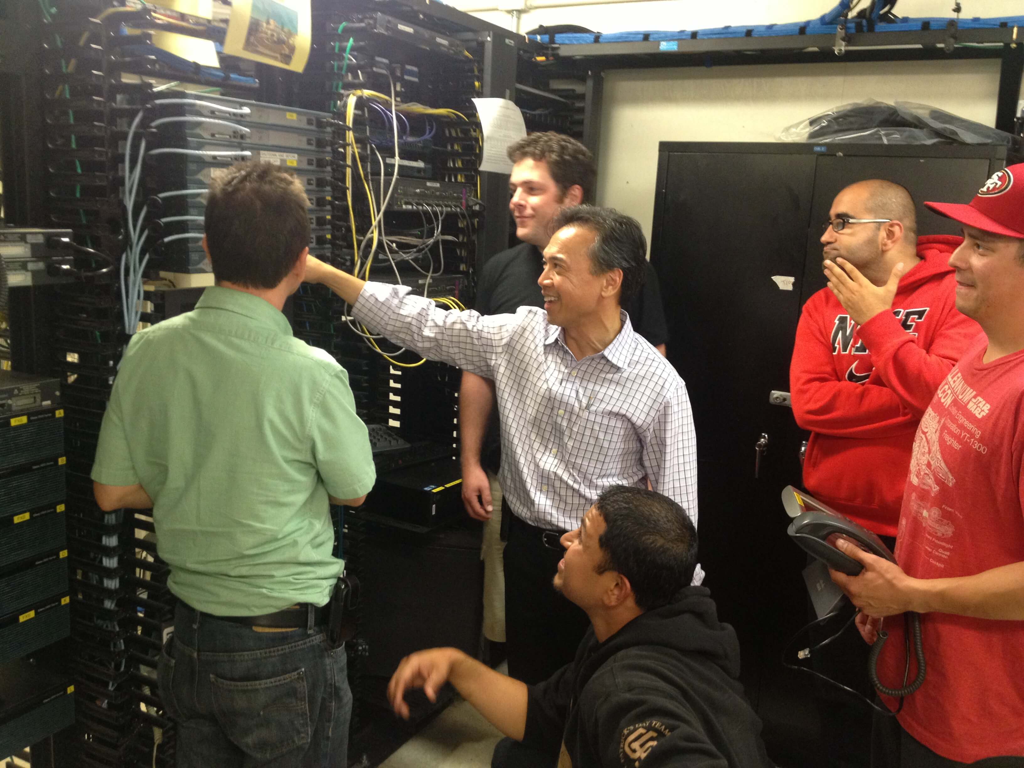 Faculty member demonstrates on the equipment to a small group of students