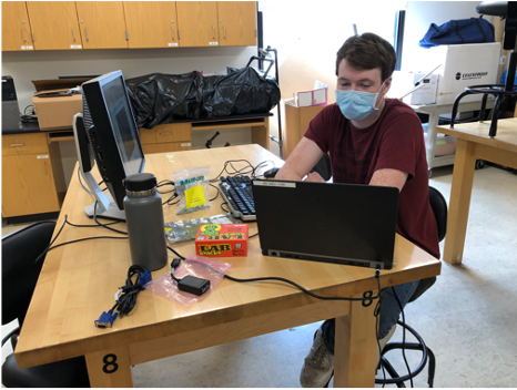 One student working on the computer in physics lab