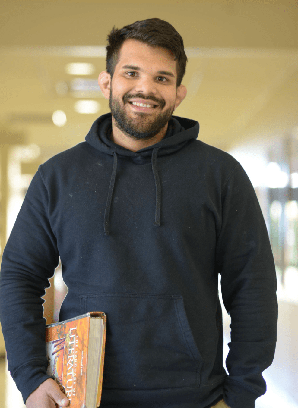 casual headshot of a smiling veteran in a black sweatshirt in the new veterans center